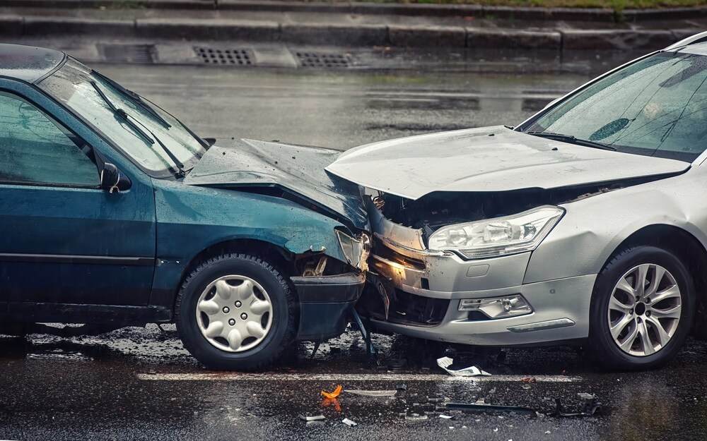 Head-on collision along the highway wet road