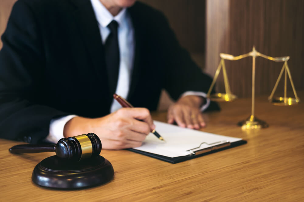 Lawyer busy signing documents in the office.