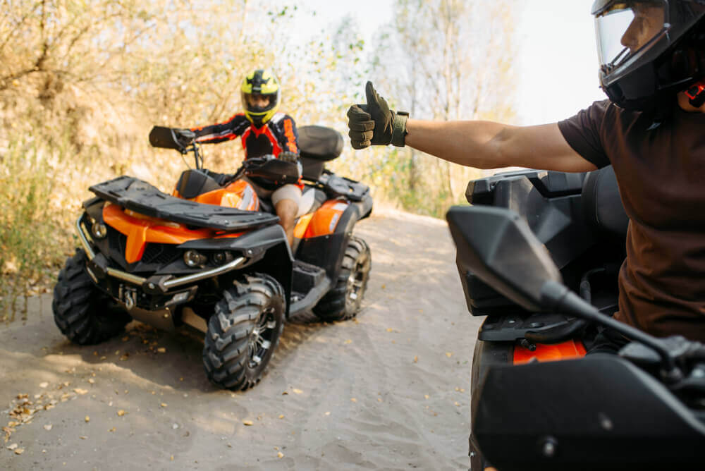 Friends riding an atv for their stroll in the countryside.