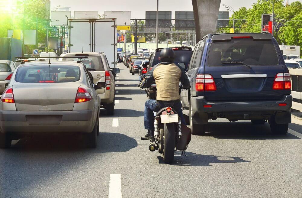 Motorcycle lane splitting in the highway.