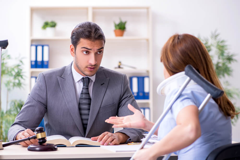 Injured female client meeting with the personal injury lawyer.