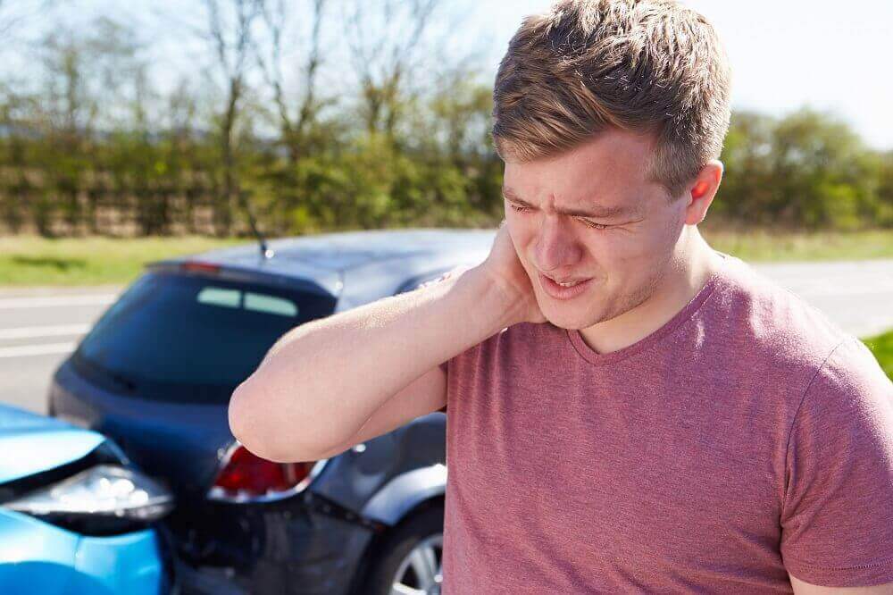 Driver suffering whiplash from car collision.