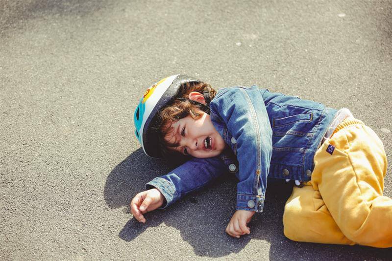 Little boy crying after falling from a bicycle