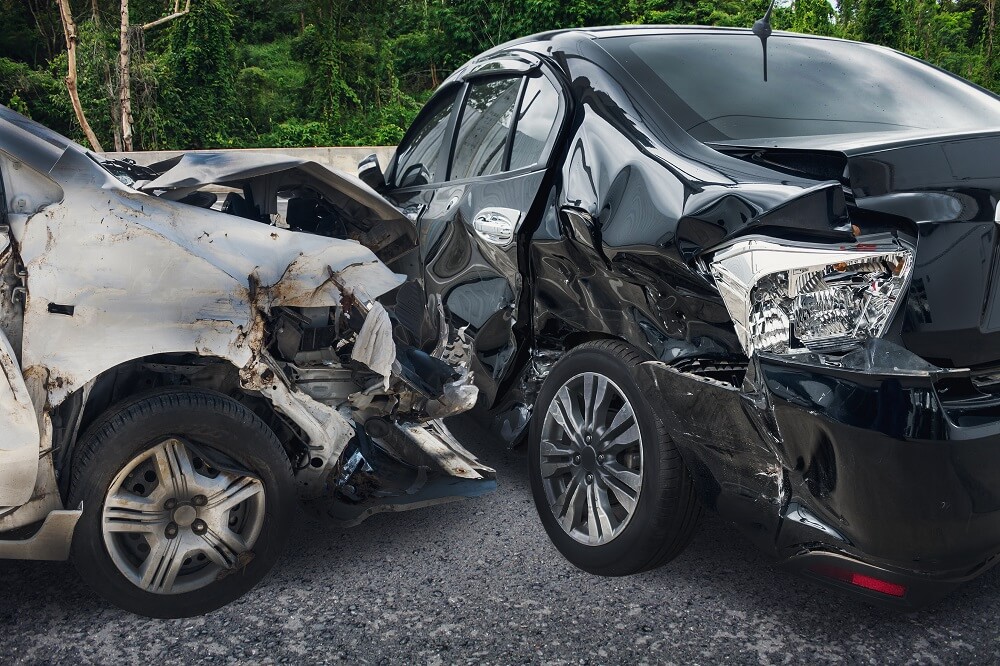 Black vs silver car crash accident on the road.