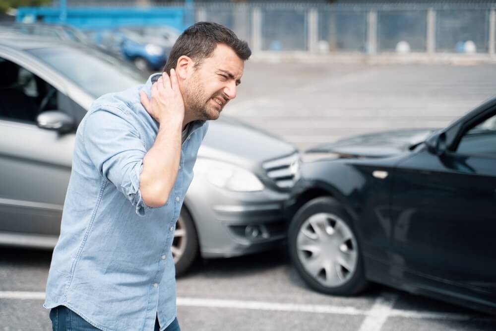 Driver suffering whiplash from car accident.
